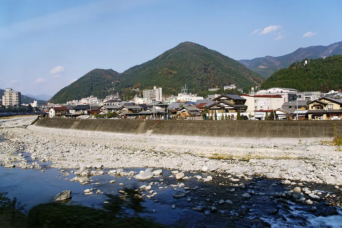 Gero Onsen across the Hida River, with mountains behind the town